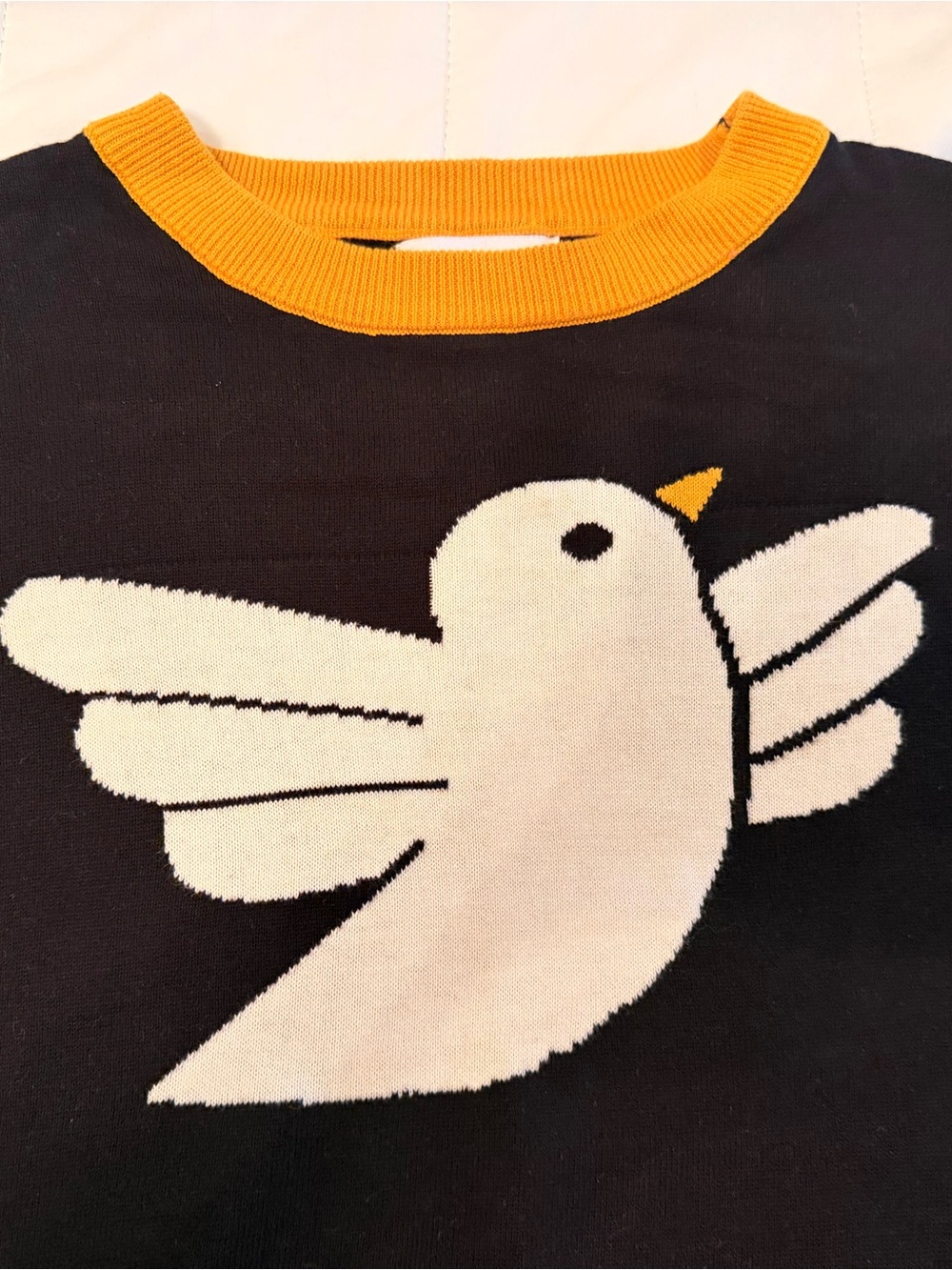 Black Crewneck Sweater with White Bird Motif and Yellow Trim